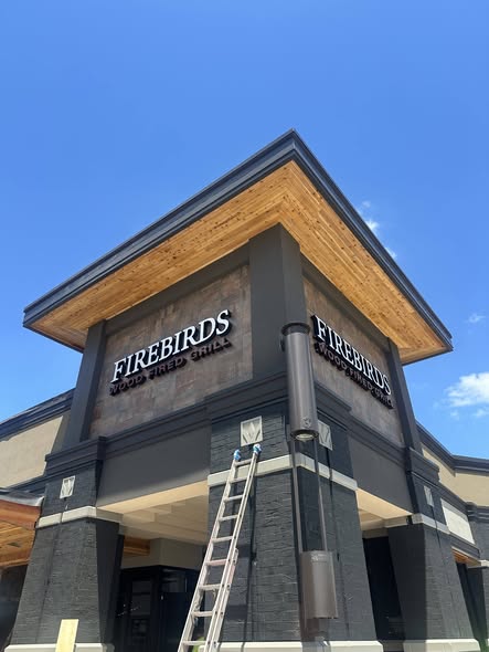 Firebirds Wood-Fired Grill exterior with wood soffit detail